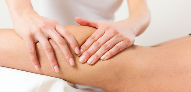Deep tissue sports massage on woman's calf image 